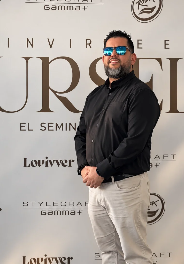 Kelvin, founder of Refugio Barber Studio, standing in a black shirt and sunglasses